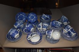 A selection of blue and white wear tea cups and saucers including Churchill and Woods