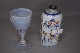 A wine glass having opalescent glass with twist cup on baluster stem with folded foot, and a white