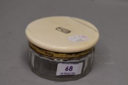 An Edwardian powder container having HM silver fitments and cut glass body