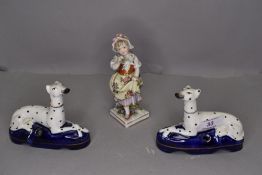 A Chelsea Derby figure of a girl with flowers and two Staffordshire pottery dalmations