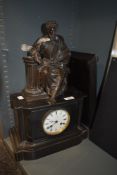 A Victorian slate cased American style mantle clock having bronze figure decoration sat atop