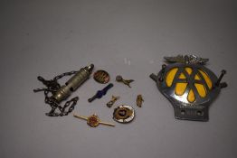 A selection of enamel pin badges, a police whistle and an AA motor car badge