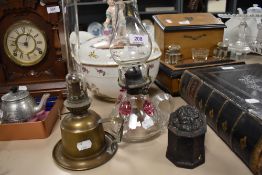 An oil burning lamp having hand blown base with similar brass example