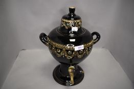 A ceramic tea urn or samovar having gilt and enamel decoration