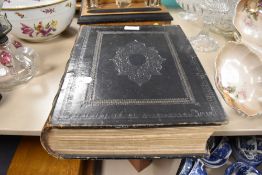 An antique family bible having embossed leather cover.