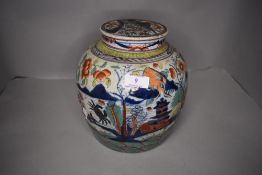 A Chinese hard paste ginger jar with ceramic lid decorated in an imari palette in a Japanese design