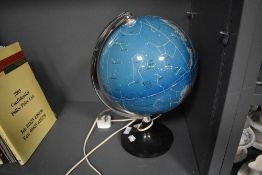 A mid century light up globe of the night sky or star charts