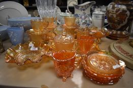 A selection of orange carnival glass ware