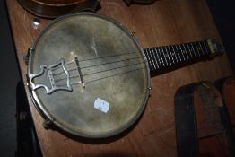An early 20th Century banjo ukulele, labelled to headstock for John Grey , London, having ply drum