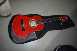 A Guvnor junior sized acoustic guitar , model GC102RD, with Stagg gig bag