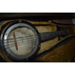 An early 20th Century banjo ukulele in need of some restoration to skin etc, in a violin case