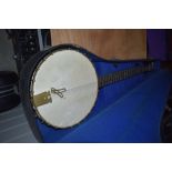 A Savana 5 string banjo having metal resonator body and card style case