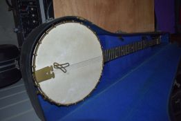 A Savana 5 string banjo having metal resonator body and card style case