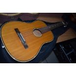 A vintage unmarked parlour style classical guitar with padded carry bag