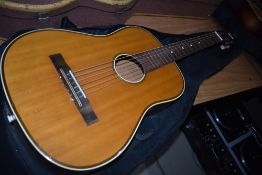 A vintage unmarked parlour style classical guitar with padded carry bag