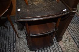 An Ercol dark stained tea trolley with drop leaves