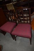A pair of reproduction Regency dining chairs having recovered tweed seats