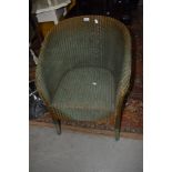 A vintage Lloyd Loom armchair in green