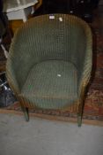 A vintage Lloyd Loom armchair in green