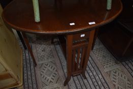 An Edwardian mahogany and inlaid Sutherland table