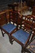 A pair of late C20th Ercol style ladder back dining chairs on turned legs