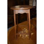 An early 20th century golden oak occasional table having circular top and slender legs, w 36cm