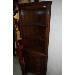 A modern quality reproduction Titchmarsh & Goodwin style corner cupboard, having open shelf top over