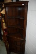 A modern quality reproduction Titchmarsh & Goodwin style corner cupboard, having open shelf top over