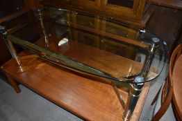 A modern glass top table having metal frame