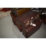 A selection of vintage suitcases inc leather