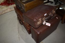 A selection of vintage suitcases inc leather