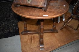 An early 20th century oak occasional table having circular top and ring turned legs and cross