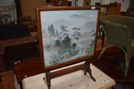 An early 20th Century mahogany folding fire screen table having Japanese silk inset