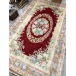 A modern Chinese carpet square, having cream and burgundy pattern, 150 x 240cm