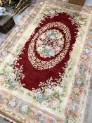 A modern Chinese carpet square, having cream and burgundy pattern, 150 x 240cm