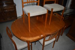 A vintage part teak oval dining table and six chairs