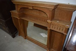 An Arts and Crafts style golden oak over mantel mirror