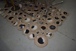 A cord and cow hide circular pattern floor mat