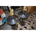 A pair of metal decorators statement piece lidded fire pit urns of classical design
