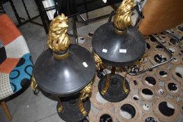 A pair of metal decorators statement piece lidded fire pit urns of classical design