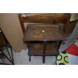 An early 20th century oak folding cake stand