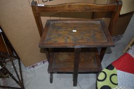 An early 20th century oak folding cake stand