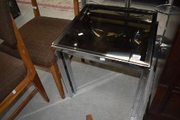 A modern chrome nest of table with glass tops