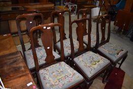 A set of six mahogany Queen Anne style dining chairs having tapestry seats and H stretchers
