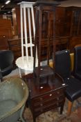 An early 20th mahogany music cabinet having fall fronts on slender legs, w 53cm