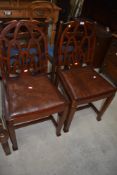 A pair of period style oak dining chairs, having Gothic arch backs with chamfered legs
