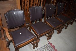 A set of early/mid C20th oak frame dining chairs having upholstered stud backs, and cup and cover