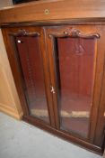 A late Victorian mahogany bookcase top, having applique glass doors, w 96cm