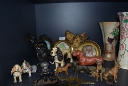 A selection of dog figures and figurines including metal cast versions and plaques