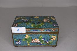 A vintage cloisonne trinket or jewellery case with floral design on blue ground